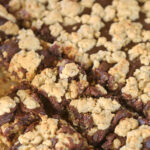 Chocolate revel bars in a pan partially cut