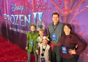Family dressed in costume on Frozen 2 Red Carpet
